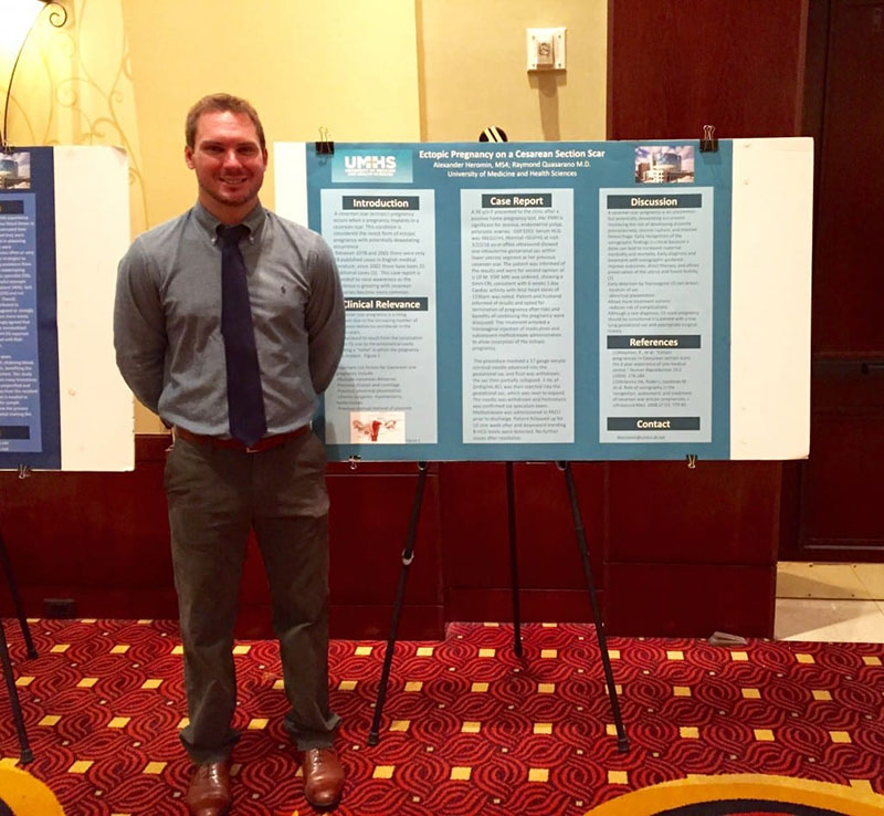 1ST PLACE WINNER: UMHS student Alex Heromin in front of his OB/GYN case report for the 31st Annual McLaren Research Symposium in Michigan. Photo: Courtesy of McLaren Oakland