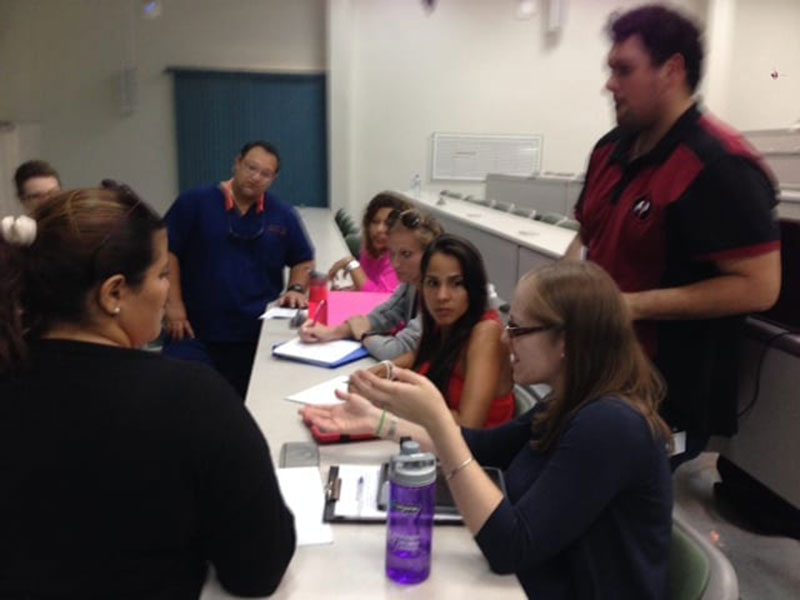 UMHS Med 4 student, Rebecca Bremner, poses questions for the patient. Photo: UMHS AMWA