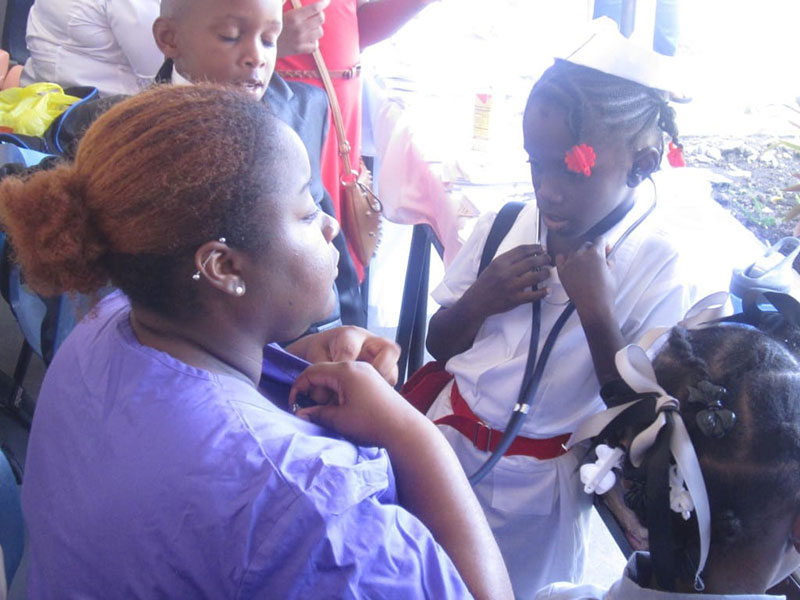 LEARNING HOW A STETHOSCOPE WORKS: UMHS student Chyanne M. Brown with one of the kids. Photo: Ludny Charles