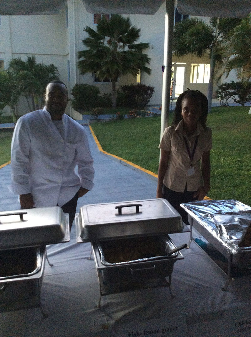 TASTE OF THE WORLD PARADE OF NATIONS: Cook Cleavon Thomas (left) with a helper. Through Patchouco Theodore, & a donation from Dr. Afolabi, Mr. Thomas created the delicious food served. Photo: UMHS ASA