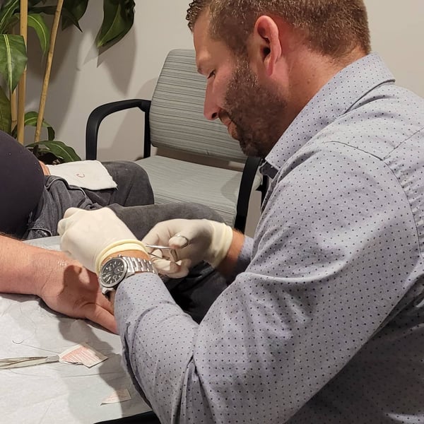 Dr. Opperman sutures a patient at his office in Centerville, OH