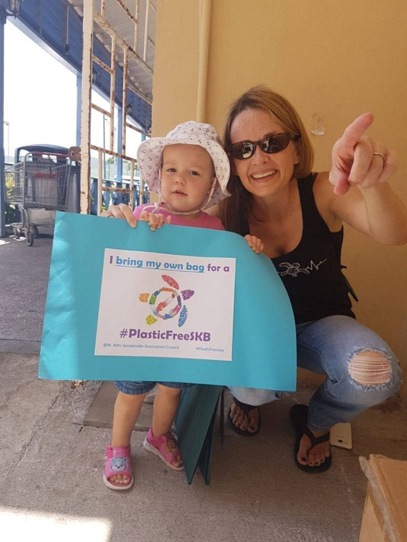 Dr. Kimberly Stewart, founder and director of the St. Kitts Sea Turtle Monitoring Network, and daughter Jess, show their support of a Plastic Free St. Kitts. Photo: Courtesy of SDC/Heart of St. Kitts Foundation