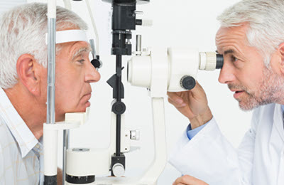ophthalmology Eye Doctor at a slit lamp performing eye exam