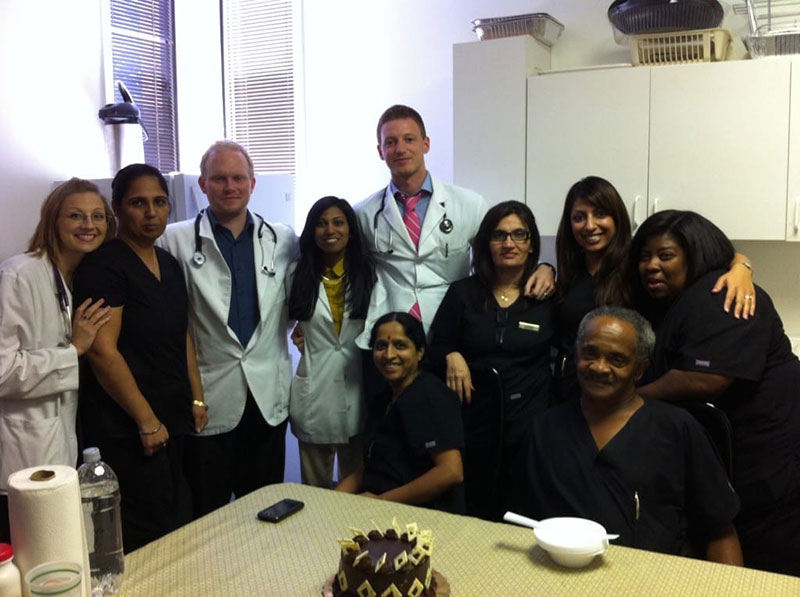 FAMILY MEDICINE ROTATION IN ATLANTA, GA: Dr. Christine Fetterolf & (from left to right in white lab coats) UMHS students Kevin Sullivan, Shanti Eckman & Jerry Eckman with office staff. This rotation introduced Dr. Fetterolf to Family Medicine. Photo: Courtesy of Dr. Christine Fetterolf