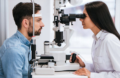Female Optometrist with patient doing an eye health exam