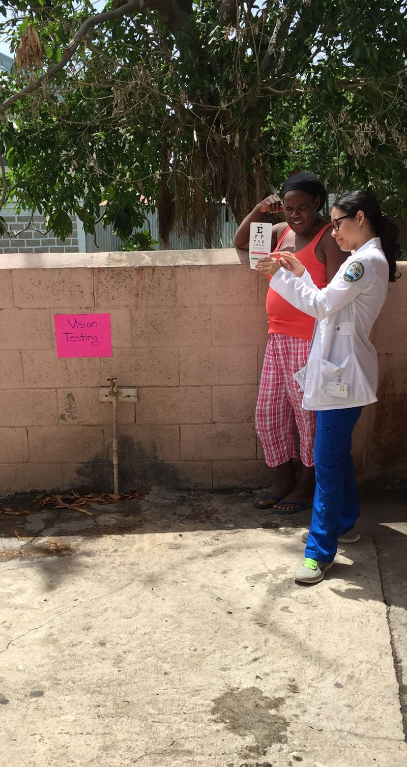 GIVING AN EYE EXAM: UMHS student Jareliz Caldas-Dias with a patient. Photo: Amy Scheuermann