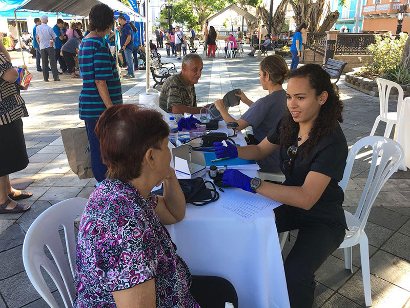 UMHS students Ariana Hernandez (top right) & Eva Rivera (lower right) helping people in need in Arecibo, Puerto Rico. Photo: UMHS Med4You