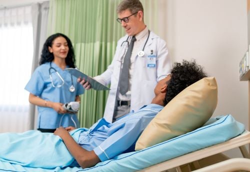 Hospitalist-with-nurse-and-patient