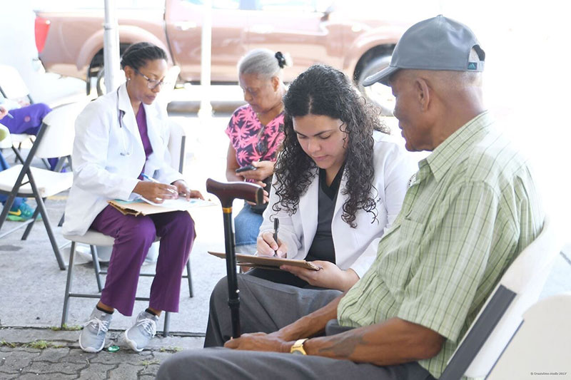 3rd and 4th semester students Nelmarie Jimenez and Taneil Gibson taking the history of patients before they begin testing at a health fair in St. Kitts back on Father's Day weekend. Photo: Courtesy of UMHS ACSA