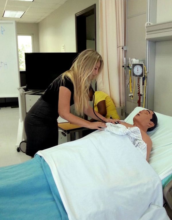 KIRSTEN FILL ON UMHS CAMPUS: Practicing physical exams on a simulation robot patient. Photo: Courtesy of Dr. Kirsten Fill