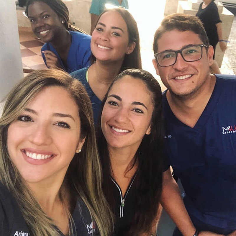 MED4YOU UMHS TEAM: UMHS student Ariana Hernandez (far left) created the nonprofit Med4You & Dr. Matos (far right) helped her also turn it into a student organization. Med4You took UMHS students on medical missions to Guatemala, Puerto Rico & the Dominican Republic. Also pictured: (center) UMHS students & Med4You members Paola Mora & (top center) Endrina Mangual & (top left, in blue) Pryia Simmons. Photo: Courtesy of UMHS Med4You