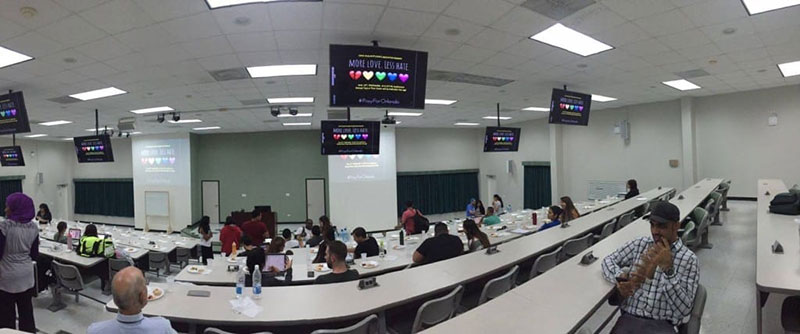 'MORE LOVE, LESS HATE': Images of support for LGBT victims in Orlando on screens at the event. Photo: Courtesy of UMHS MSA