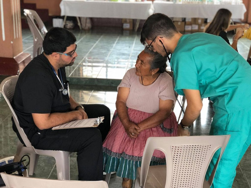 Med4You members Carlos Meija & Jiomar Santiago doing a medical history & physical examination of a patient in the Magadalena Milpas Altas community in Guatemala. Photo: UMHS Med4You