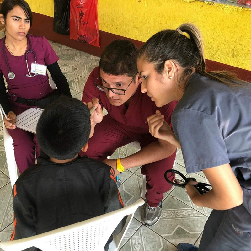 (Left to right) Karen Nieves, Dr. Angel Matos & Ariana Hernandez helping a child from Santa Lucia Milpas Altas, Guatemala. Photo: UMHS Med4You