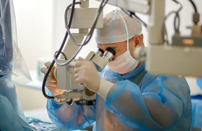 Ophthamologist performing eye surgery