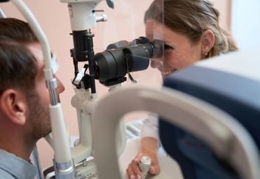 Optometrist-looking-at-front-of-eye-with-biomicroscope