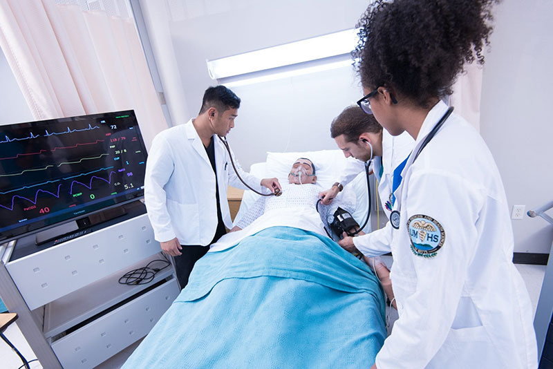 DO PAID OR VOLUNTEER WORK IN HEALTH-CARE SETTING BEFORE MED SCHOOL: UMHS VP of Admissions Marie McGillycuddy recommends gaining experience in a health-care setting before applying for med school. Pictured: UMHS med students hard at work in the high-tech simulation lab . Photo: UMHS Files