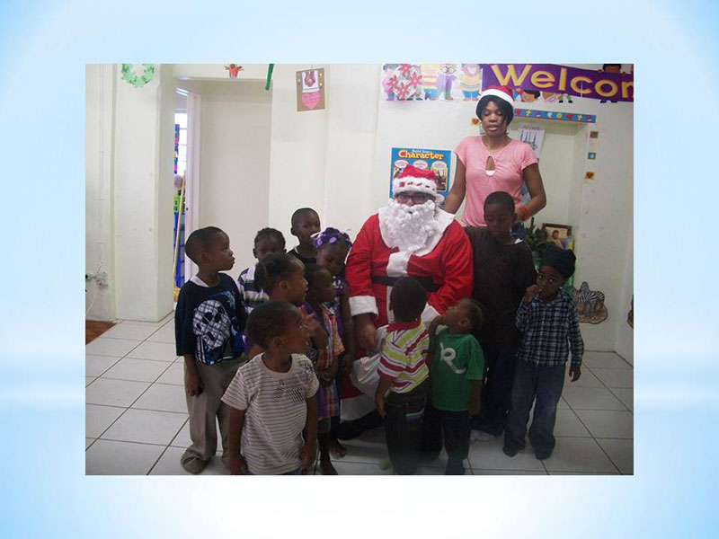 SPREADING CHRISTMAS CHEER: UMHS SGA President Chris Garcia dressed as Santa for a Christmas party with the kids last December at the Holy Spirit Catholic Preschool. The UMHS African Students Association (ASA) & many UMHS students have volunteered to help the school in Molineux, St. Kitts. Photo: Courtesy of Holy Spirit Catholic Preschool.