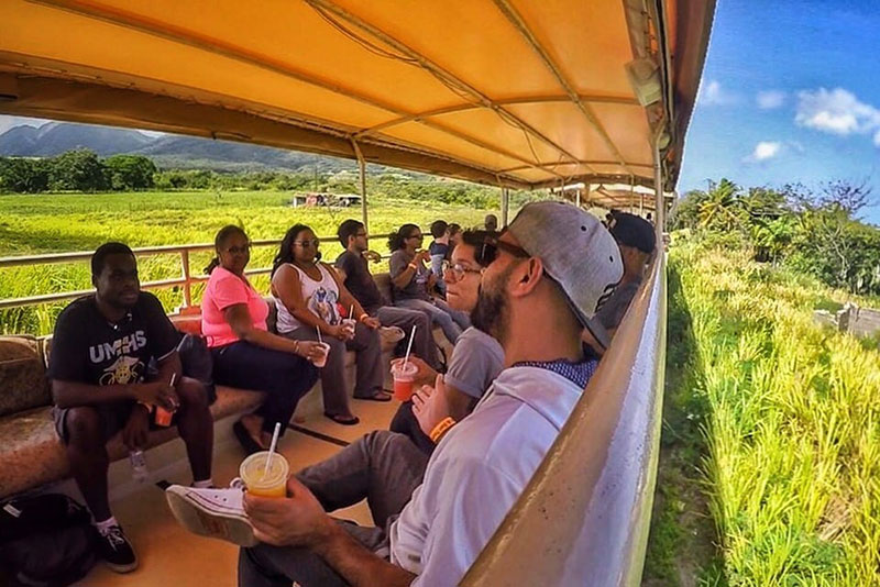 New UMHS students and family members enjoy a ride on the St. Kitts Scenic Railway as part of Welcome Week activities. Photo: @worldlymeander