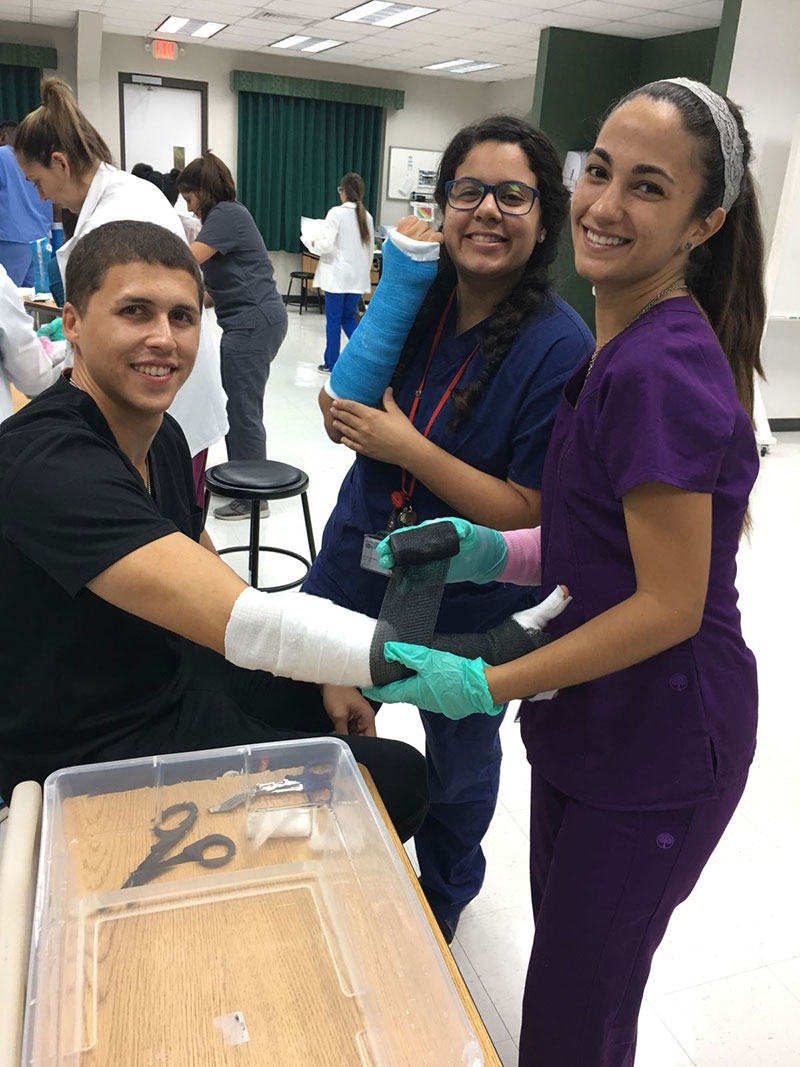 Students applying a case while wearing one. 'It was kind of funny as most students wanted to keep their cast on for a while, which means they had to try casting with a cast on,' Dr. Doherty said. (Left to right): Samuel Urrutia, Gianna Nieves Maldonado, Paola Mora Morrera. Photo: Dr. Michael Doherty