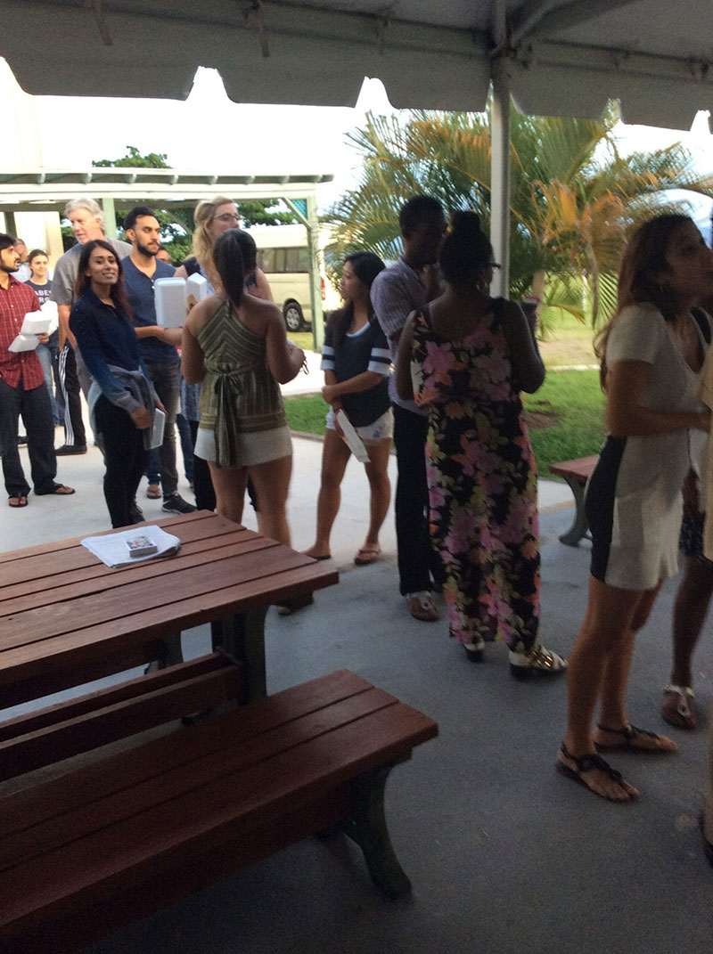 TASTE OF THE WORLD PARADE OF NATIONS: Students line up for great fish, chicken, pork & mutton dishes being served. Photo: UMHS ASA