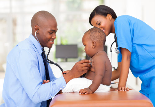 black male pediatrician examining a pediatric patient