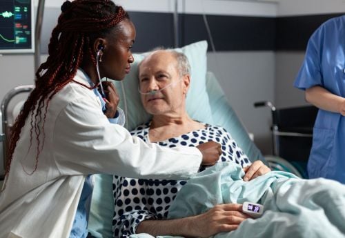 black-female-doctor-with-elderly-male-patient-1
