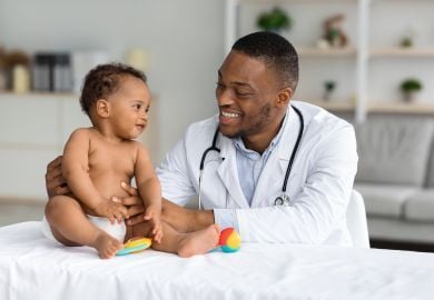 black-pediatrician-examining-infant