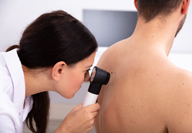 dermatologist-looking-at-skin-irregularity