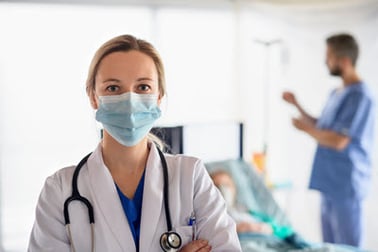 hospitalist physician with mask on a professional visit