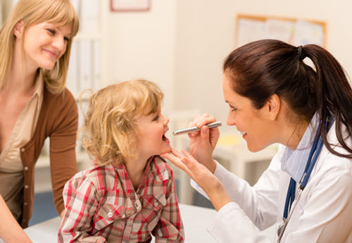 female pediatric specialist examining a child