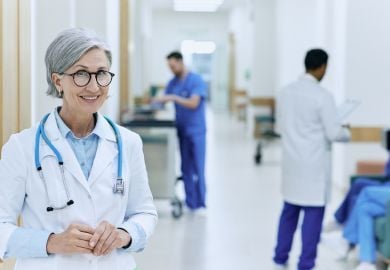female-hospitalist-physician-in-hospital-hallway