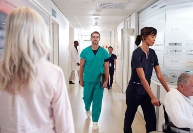 hospitalist-doctor-walking-in-hospital-corridor