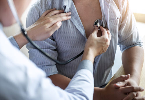 general health management by an internist with stethoscope examining 