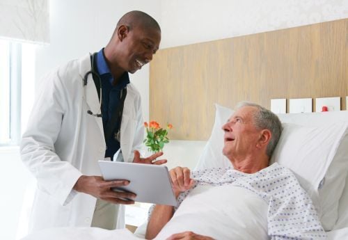 medical-fellow-with-senior-patient-in-hospital