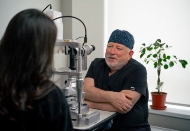 ophthalmologist-at-slit-lamp-consulting-with-woman