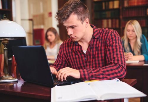 premed-postbacc-student-studying-on-laptop