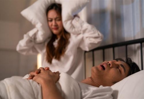 women-being-woke-up-by-sleep-apnea-snoring-of husband