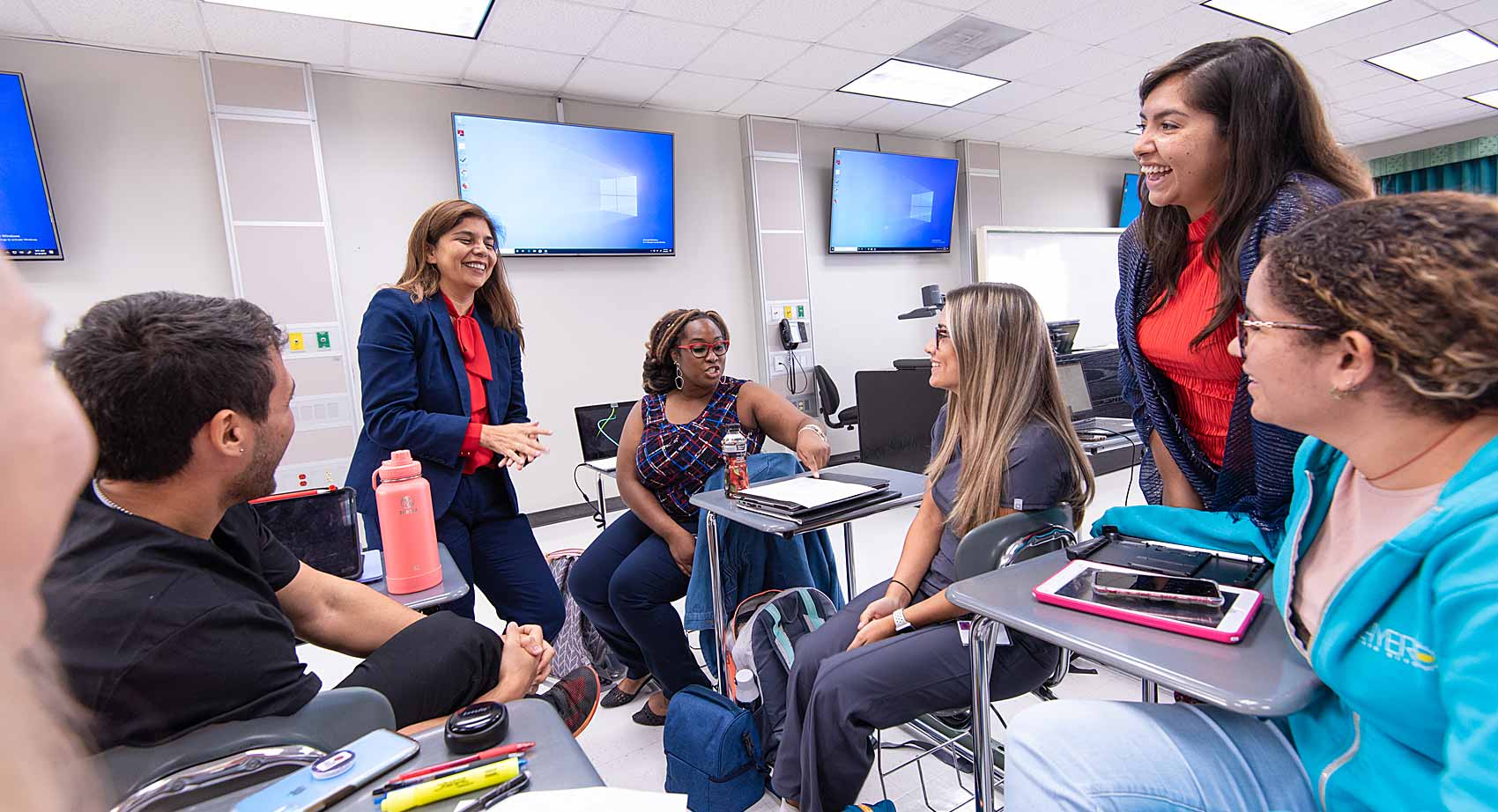 Students and professors conversing in student lounge